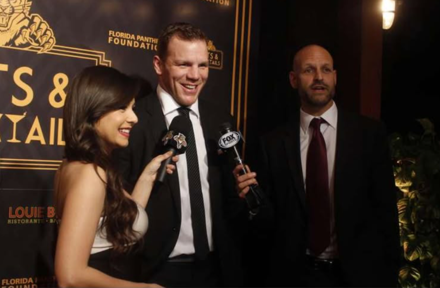 Andrea Ocampo interviewing guests at a Florida Panthers gala