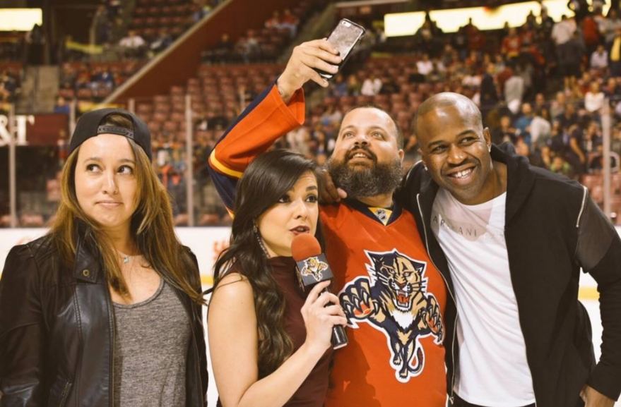 Andrea Ocampo taking a selfie with Florida Panthers fans at the arena